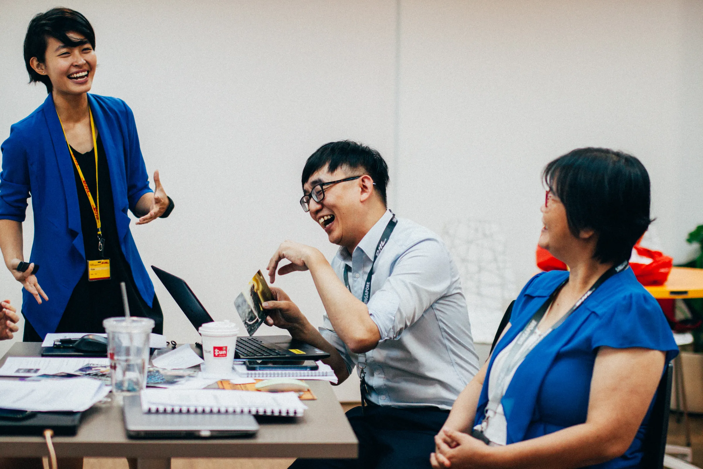 Colleagues working through materials around a workshop table