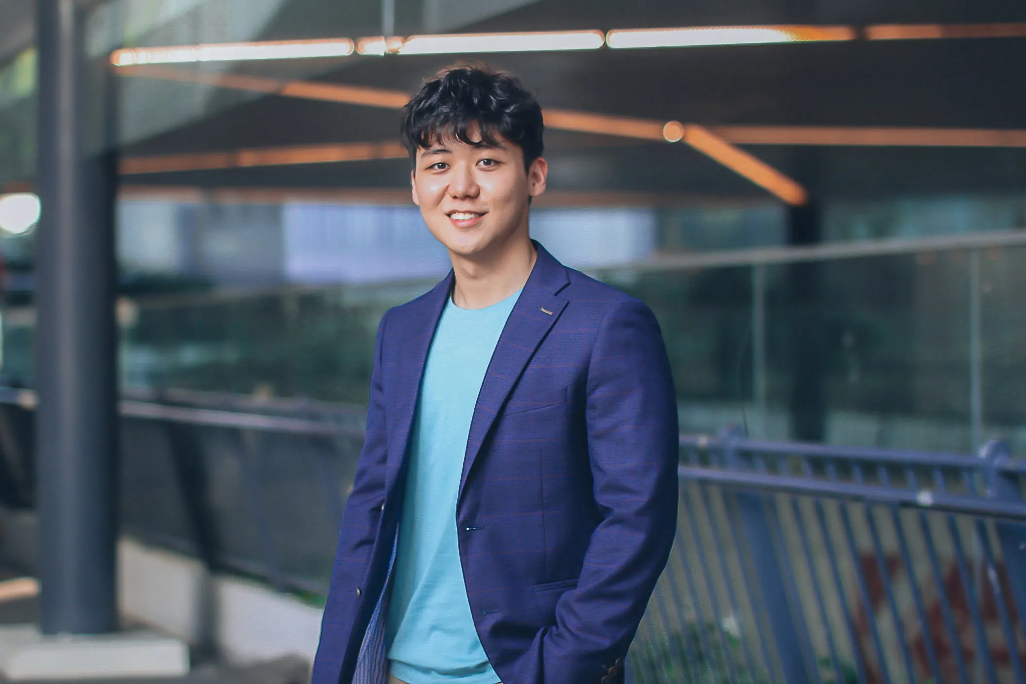 Eugene Cheng standing in a modern office setting
