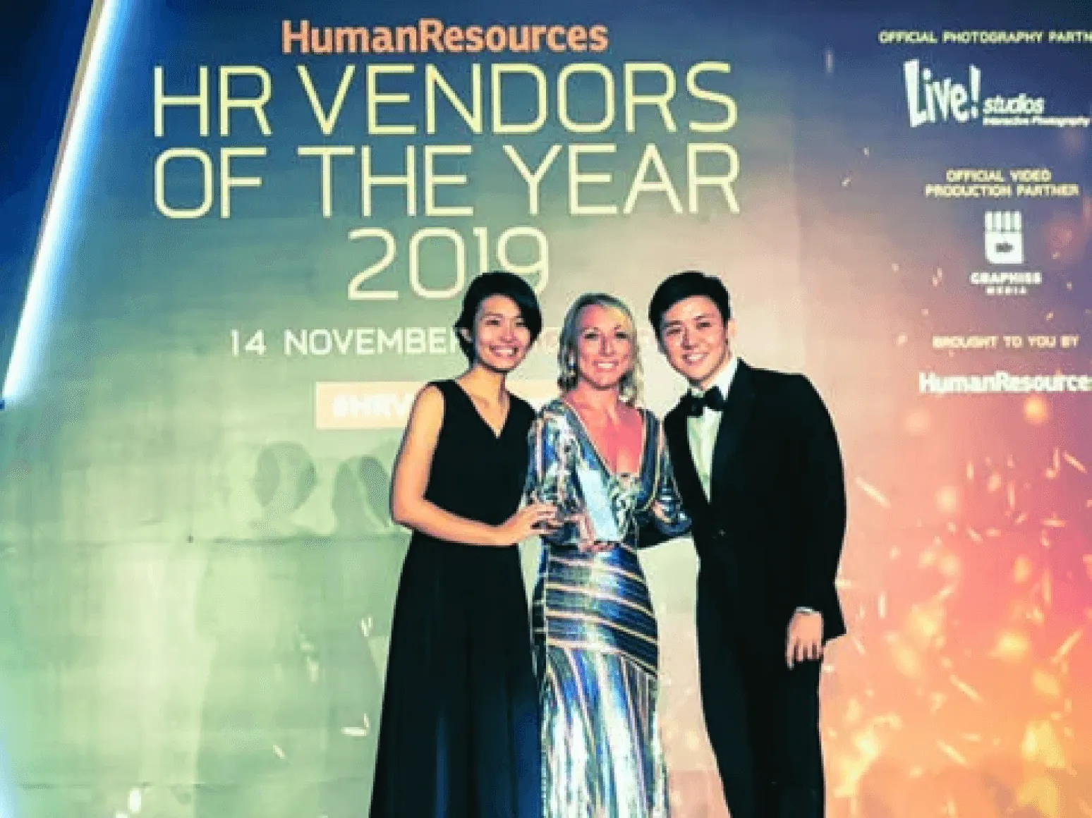 Three people on stage at the HR Vendors of the Year 2019 awards