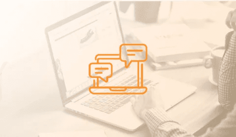 Faded photo of hands on a laptop with an orange chat icon